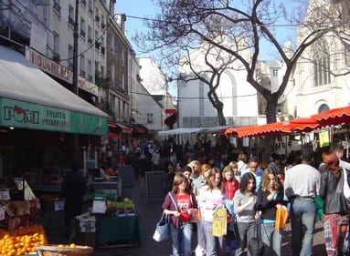 a crowded street market in paris, france